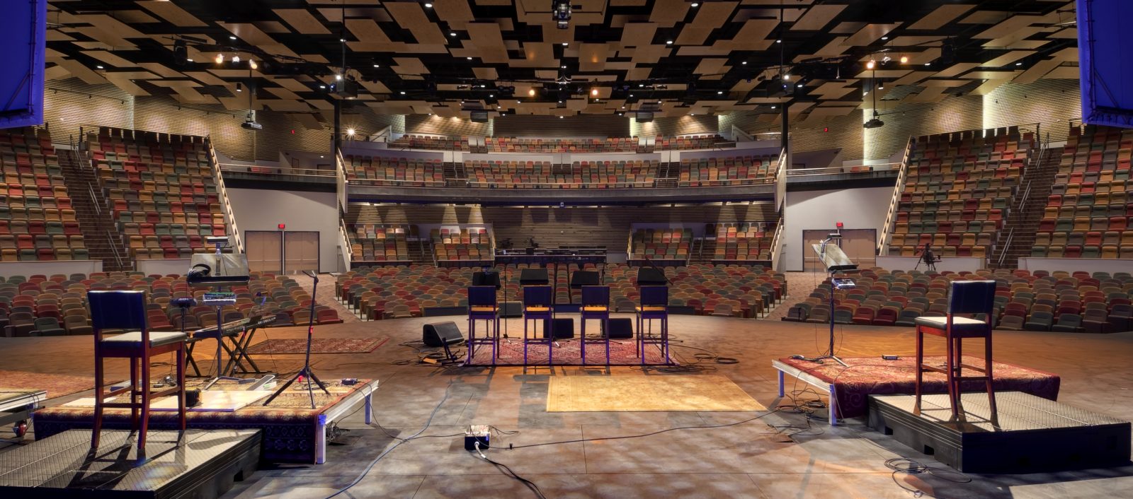 Interior of the Watermark church looking out from the stage on to stadium seating.