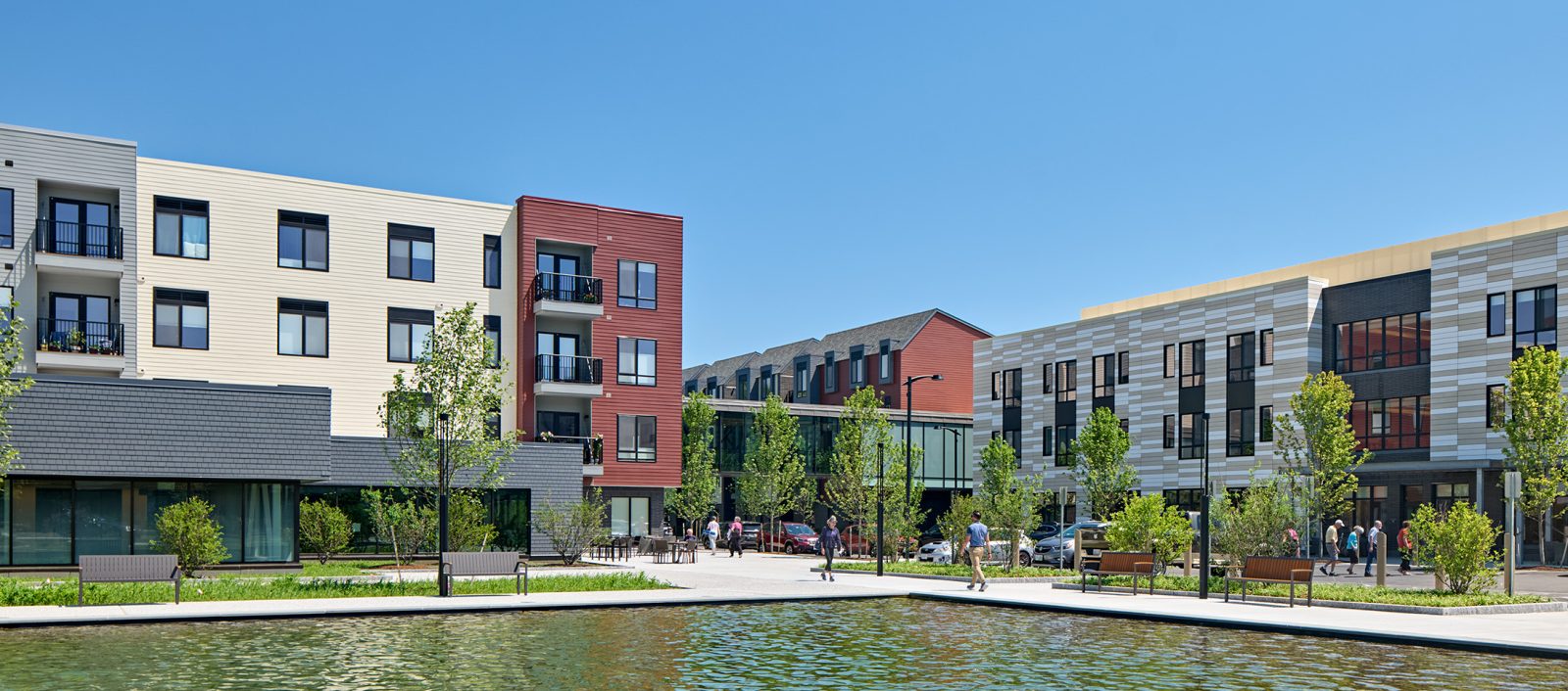 Exterior wide view of the Baldwin complex featuring a body of water and buildings made of various materials.
