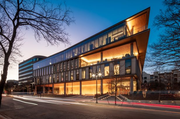 Exterior view of office building at 2915 Vine Street in Dallas, Texas at dusk featuring illuminated hallways and modern architecture.