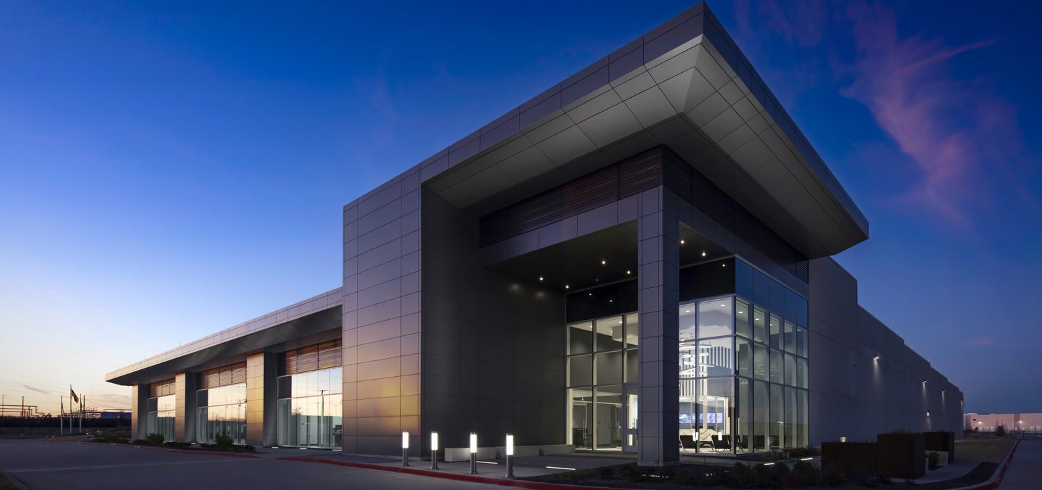 Stream DFW VII Data Center, exterior of data center building at night highlighting the structural engineering