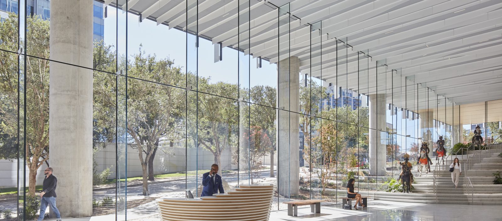 Bright and airy interior of Harwood No. 14, featuring a large glass window wall, natural light, and sleek white floors and ceilings.