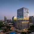 Harwood No. 14, a modern high-rise office building designed by our structural engineering team, located in a vibrant urban area at dusk
