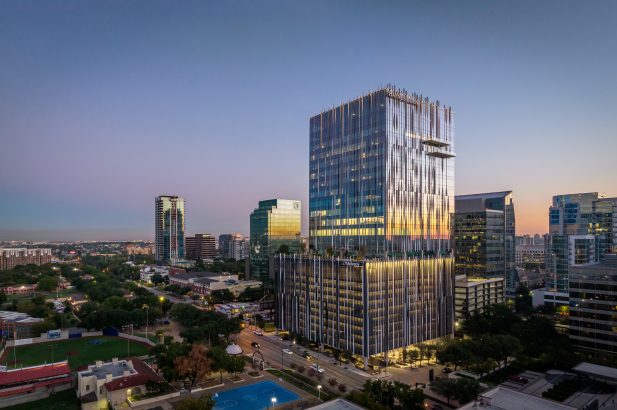 Harwood No. 14, a modern high-rise office building designed by our structural engineering team, located in a vibrant urban area at dusk