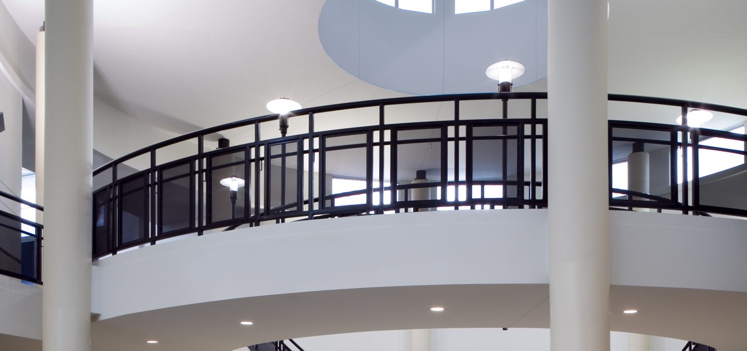 Lancaster ISD High School Lobby with an arched bridge walkway leading to the ground level.
