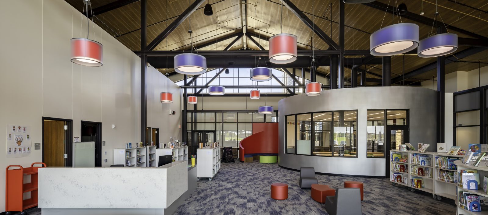 Library at Jackie Fuller Elementary School in Aubrey ISD, featuring modern decor, colorful lighting, and seating areas.